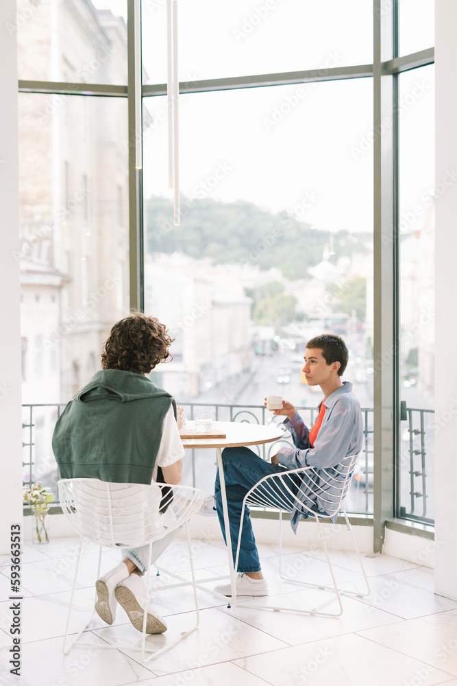Friends in Cafe With Panoramic View Enjoying Atmosphere Friends in Cafe With Panoramic View Enjoying Atmosphere