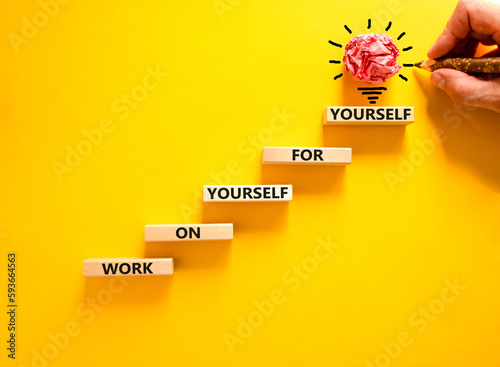 Work for yourself symbol. Concept words Work on yourself for yourself on wooden block. Beautiful yellow table yellow background. Businessman hand. Business and work for yourself concept. Copy space. photo