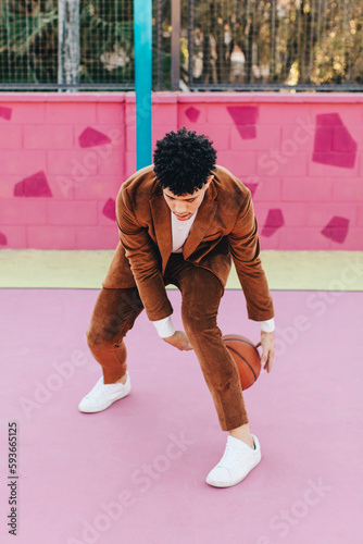 Man in a suit playing basketball