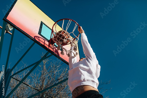 Basketball player scoring a basket photo