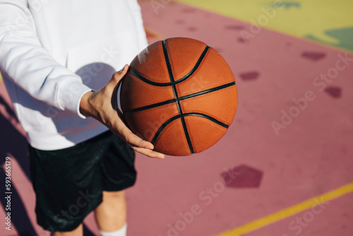 Detail of a basketball ball on a colorful court photo
