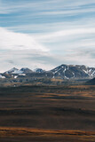 Epic north landscape with snowy mountains and brown desert hills