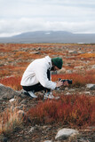 Hiker woman taking photo or filming landscape scenery