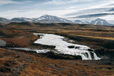 North landscape: waterfall with glacier river, volcanic snowy mountain