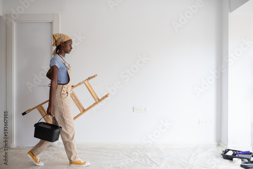 African American female painter walking in light flat