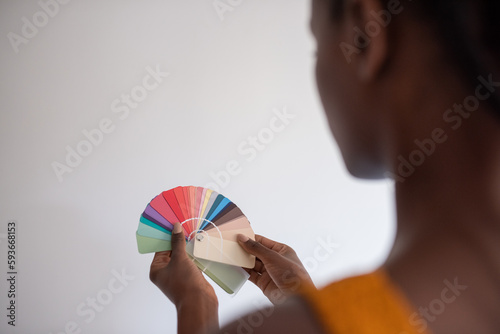 Black designer choosing color from palette