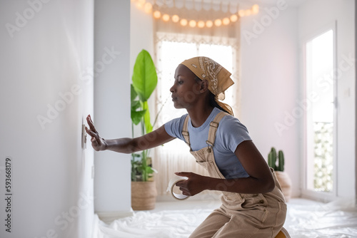 Black woman attaching tape to outlet