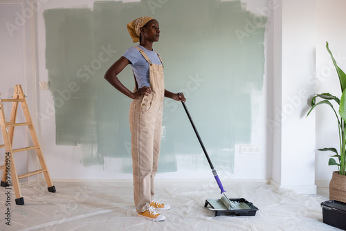 African American painter looking away during work