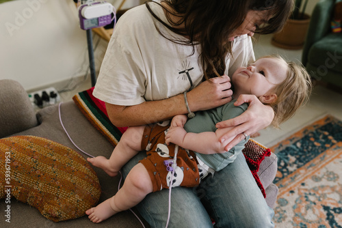 Mother with a baby who needs food through the tube photo