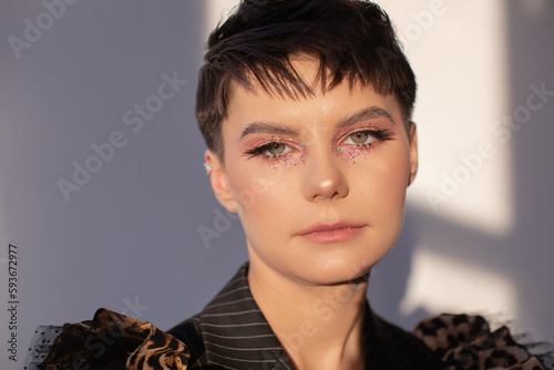 Beauty portrait of androgynous woman with short dark hair