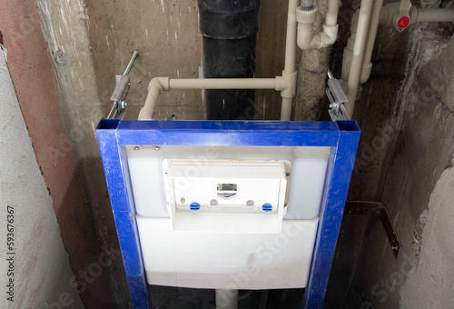 Installation of a new wall-hung toilet with a water drain installation, close-up