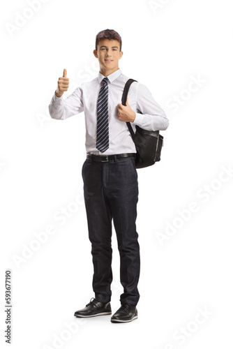 Caucasian teenage male student posing and gesturing thumbs up