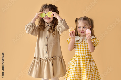 Children play with colored cookies. photo