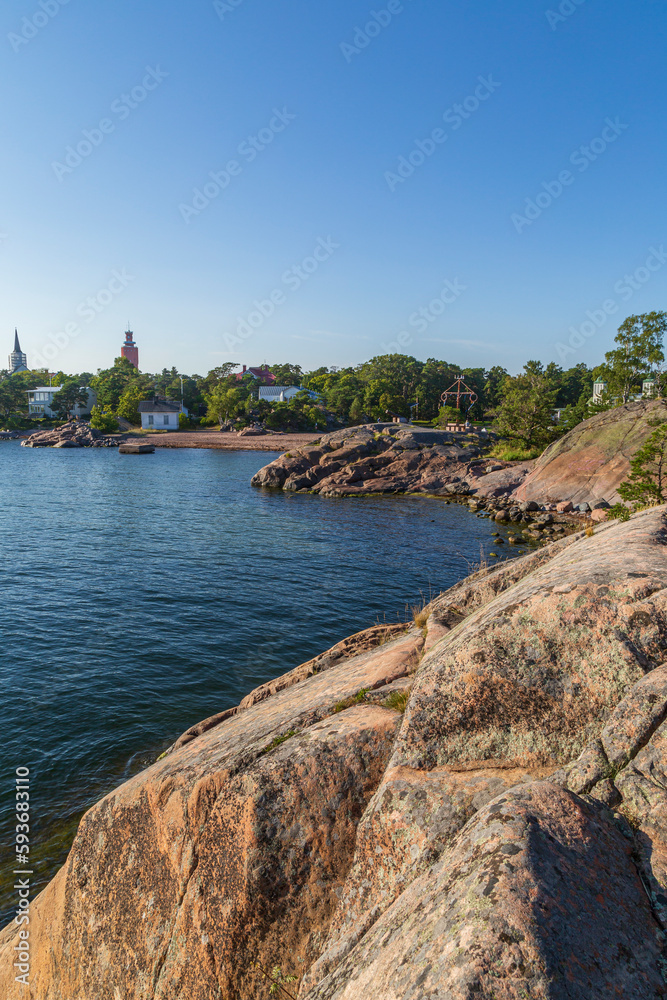 Cityscape, rocky coastline and shoreline cliffs at Puistovuori in Hanko, Finland, on a sunny day in the summer.