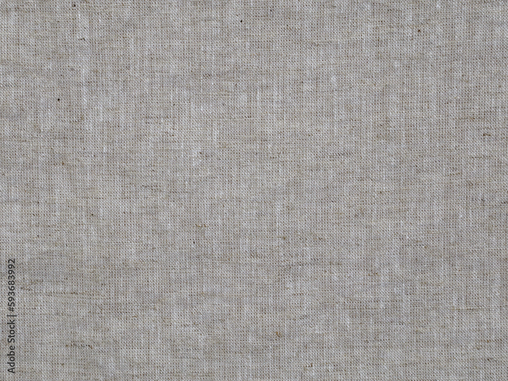 Fototapeta premium The texture detail of woven linen fabric material is shown in a closeup view.