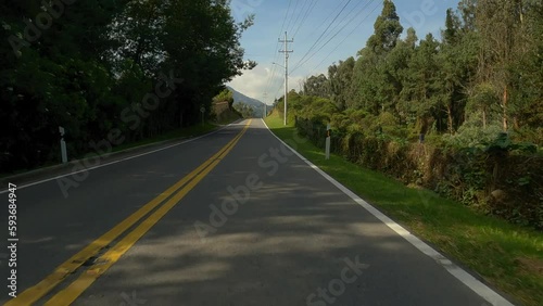 Driving in a highway near to the forest and lake