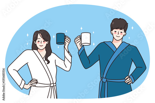 Happy young couple in bathrobes hold mugs drinking coffee in morning welcome new day. Smiling man and woman with cups have breakfast at home together. Habit concept. Vector illustration.