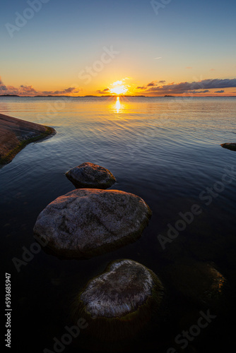 Beautiful view of rocks with seaweed in the Baltic Sea in Hanko, Finland, at sunset in the summer.
