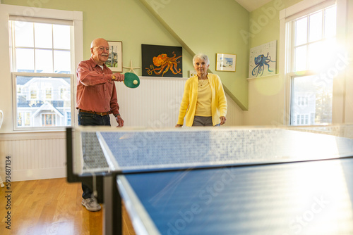 Retired Senior Citizen lifestyle couple playing ping pong game  home  photo