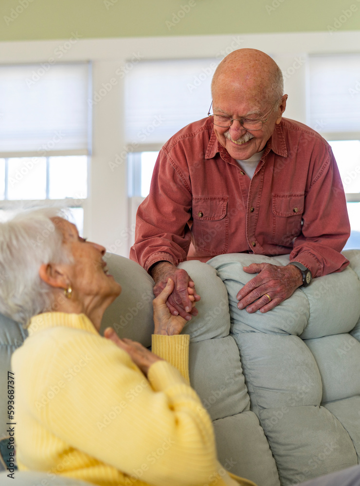 Happy and healthy senior citizen couple at home holding hands Happy and healthy senior citizen couple at home holding hands