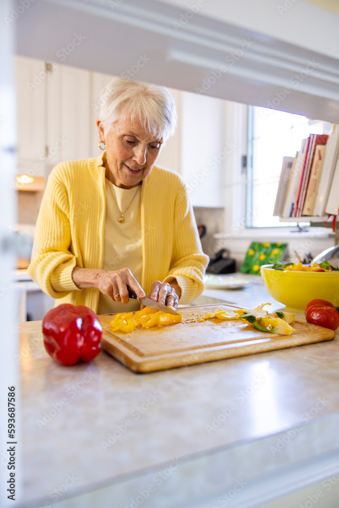 Senior Citizen woman family at home cooking and cutting food Senior Citizen woman family at home cooking and cutting food