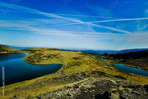 Seven Rila lakes view with green fields and mountains around, clear sky background