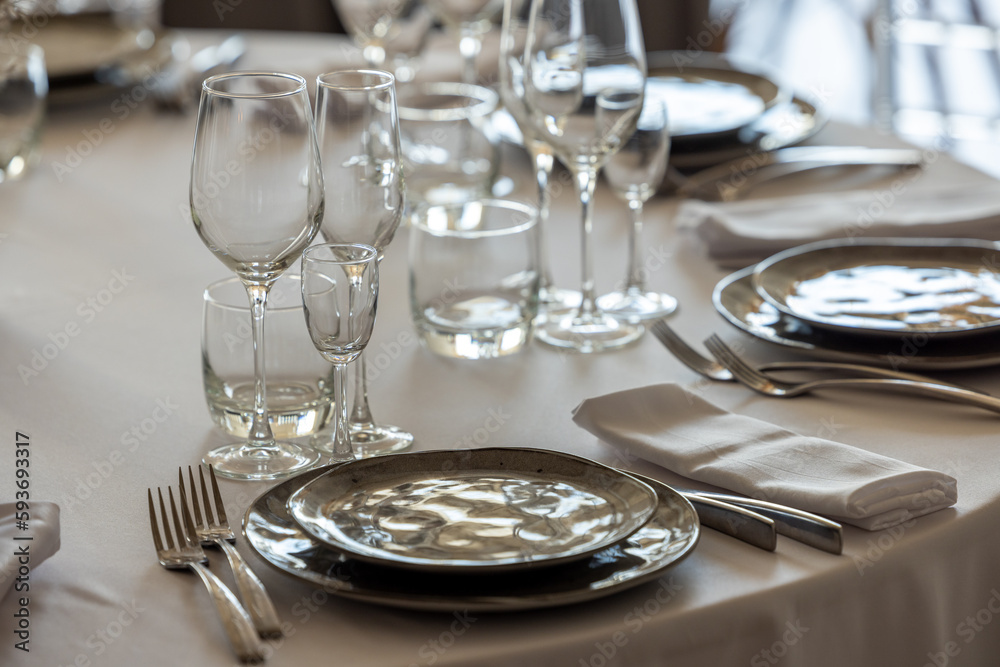 Fototapeta premium table setting. Glassware and cutlery for catered event dinner.