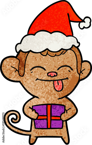 funny textured cartoon of a monkey with christmas present wearing santa hat