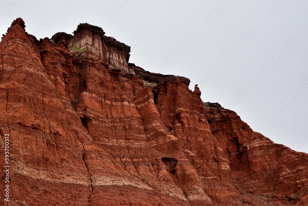 Red steep sandstone formations in Palo Duro Canyon State Park in Texas Red steep sandstone formations in Palo Duro Canyon State Park in Texas