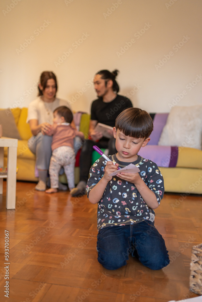 Little Boy Drawing On A Paper With A Marker Little Boy Drawing On A Paper With A Marker