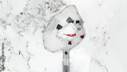 Swiss flag over a peak walk in the alps aerial view by drone
