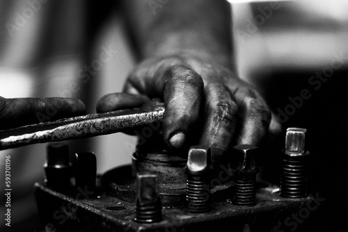 Closeup of human hand working with metallic tools