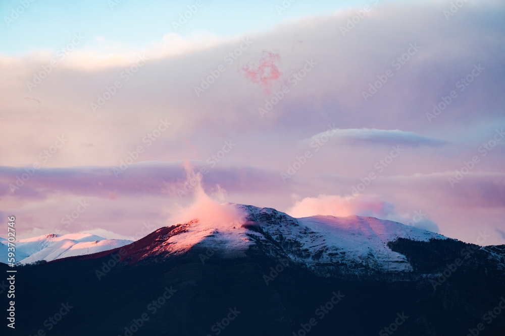 Stunning view of snowcapped mountains during a beautiful sunset.