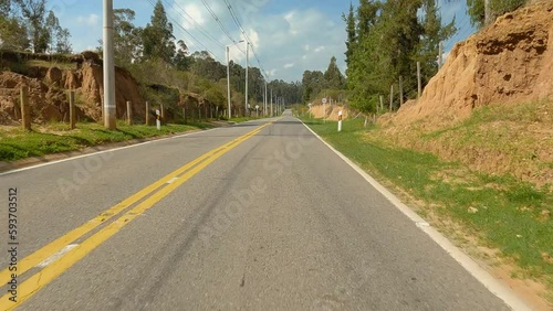 Driving in a highway near to the forest and lake