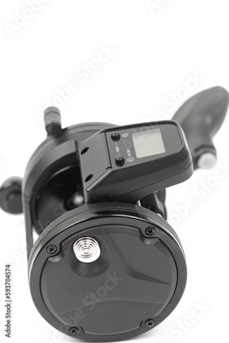 Black fishing reel baitcast isolated above white background