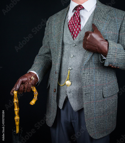 Portrait of Man in Tweed Suit and Leather Gloves Holding Umbrella. Vintage Style and Retro Fashion of Classic English Gentleman.