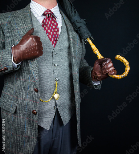 Portrait of Man in Tweed Suit and Leather Gloves Holding Umbrella. Vintage Style and Retro Fashion of Classic English Gentleman.
