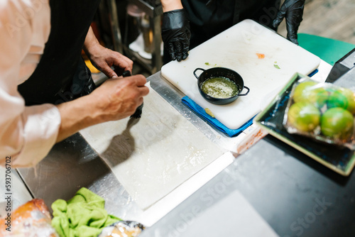 Crop cook basting dough sheet with oil photo