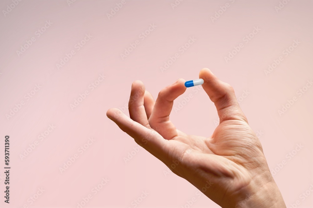Hand holding the medical pill or supplements Hand holding the medical pill or supplements