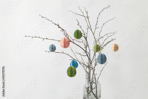 Decorative ornaments made of paper hung on twigs.
