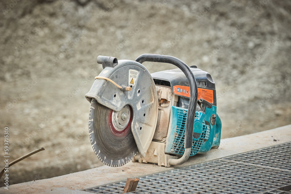 Sidewalk construction progress, blue angle grinder work, cutting and finishing concrete curbs