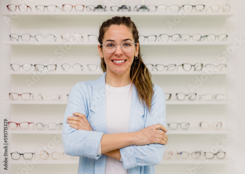 Smiling woman wearing eyeglasses in optic store photo