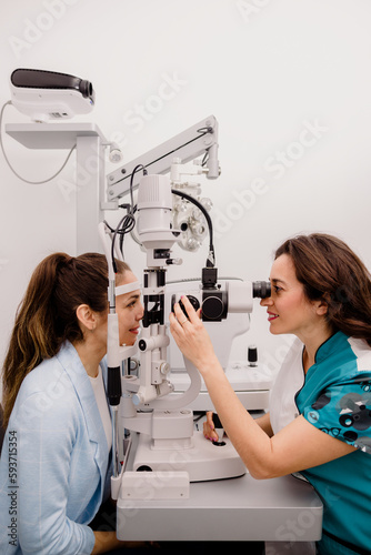 Female optometrist checking patients eyesight