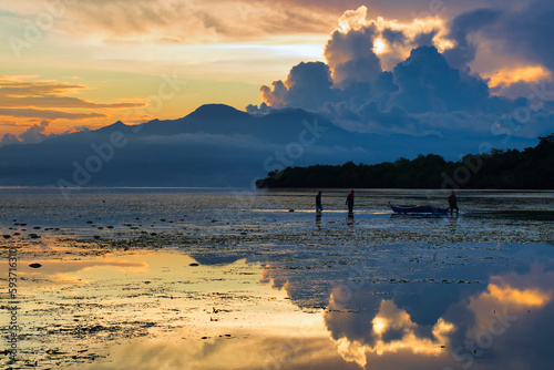 Fisherman in sunset in the island of Siquijor in Philipines. Siquijor island in Filipines- Sunset light in linely island.  Filipinas landscape with golden light. Golden hour. 