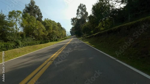 Driving in a highway near to the forest and lake