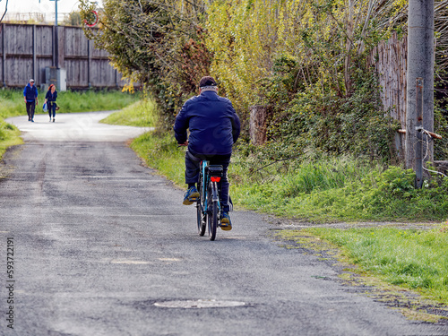 Wallpaper Mural Old senior man riding a bicycle, biking on the rural countryside roads Torontodigital.ca