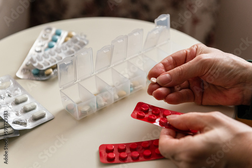 Organizing pills / drugs into pill box / organizer at home