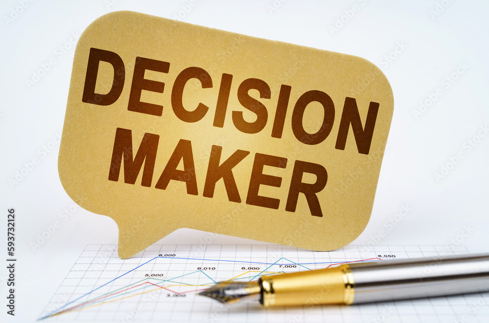 On the business diagram is a pen and a sign with the inscription -DECISION MAKER On the business diagram is a pen and a sign with the inscription -DECISION MAKER