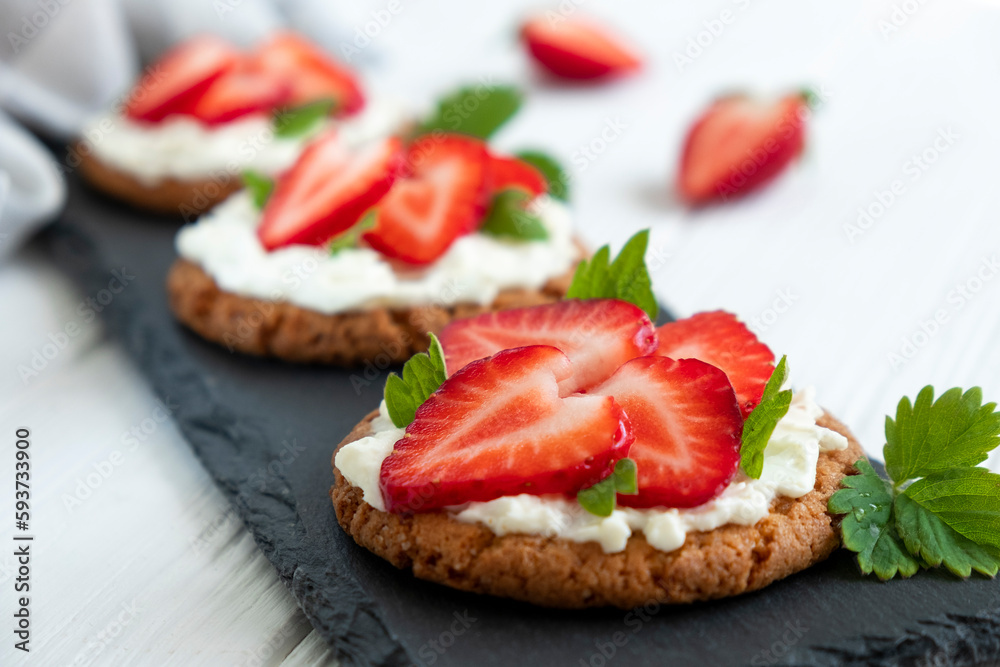 Healthy toast with strawberry, cream cheese and mint leaf. Tasty breakfast. Clean eating, dieting or recipe of healthy snack sandwich for vegetarian. Restaurant serving on slate board. Healthy toast with strawberry, cream cheese and mint leaf. Tasty breakfast. Clean eating, dieting or recipe of healthy snack sandwich for vegetarian. Restaurant serving on slate board.
