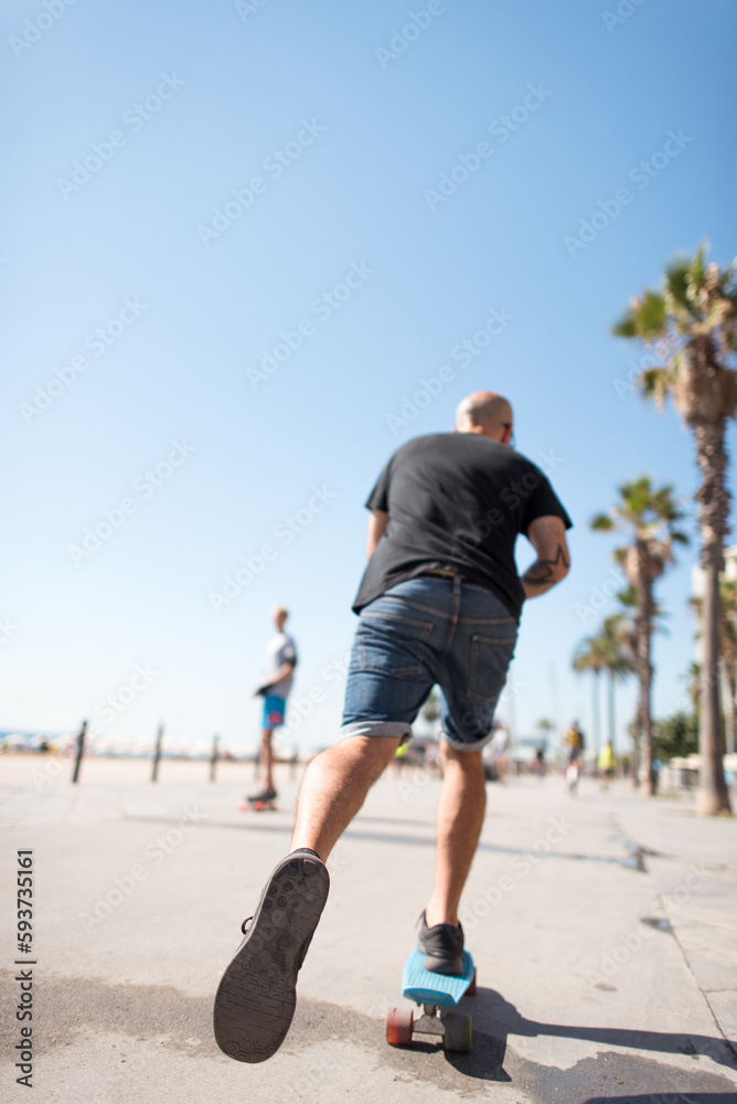 Man skating at beach promenade Man skating at beach promenade